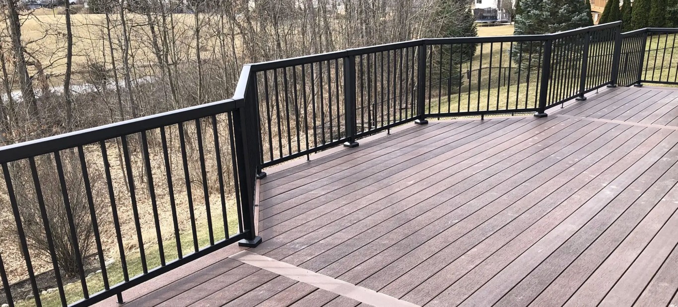 Durable composite deck surface with black metal railings